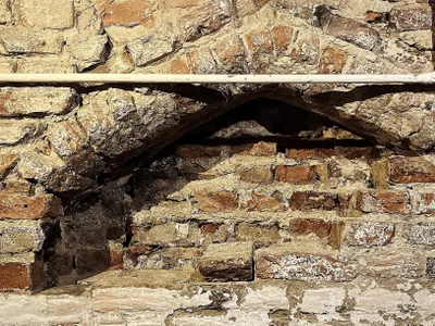 The medieval archway was buried beneath layers of plaster and brick.