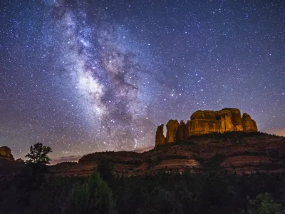 The Milky Way lights up the sky over Cathedral Rock in the Coconino National Forest in Sedona, Arizona.