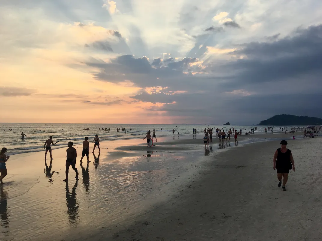 Beachgoers enjoy the sunset on Juquehy Beach.