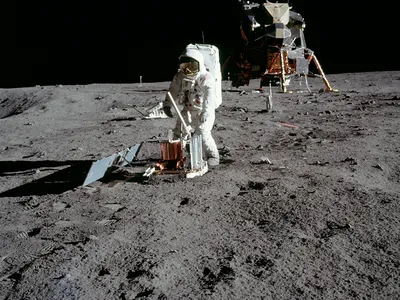 Apollo 11 astronaut Buzz Aldrin deploys a device to detect moonquakes during the first moonwalk.