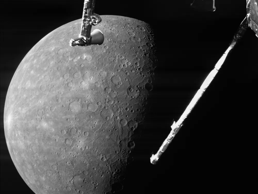 Black and white photo of rocky planet with spacecraft instruments in the foreground