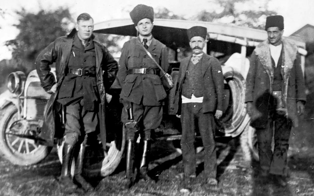 Imbrie (left) poses in front of a vehicle in Tehran in 1924