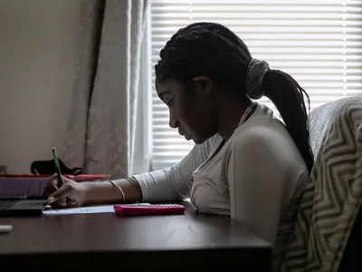 Abigail Previlon, 13, takes part in online learning at home on October 28, 2020 in Stamford, Connecticut. At the time, Stamford Public Schools was using a hybrid educational model due to the Covid-19 pandemic.