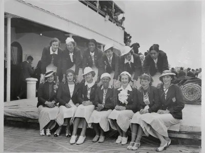 A few of the Olympians pose for a photo upon their return to the U.S. after the 1936 Games. In the back row, on the far right is Tidye PIckett and third from the left is Louise Stokes.