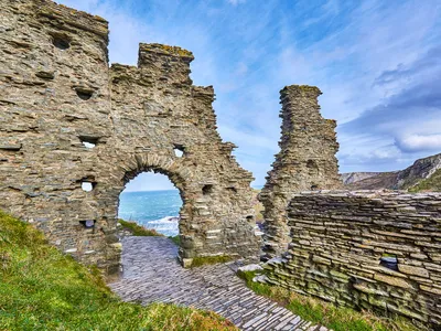 Tintagel Castle, a dramatic 13th century fortress on the rocky coast of Cornwall, England, has been associated with King Arthur.