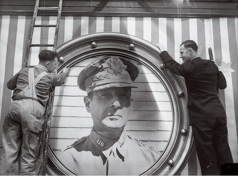 a portrait of General MacArthur being hung