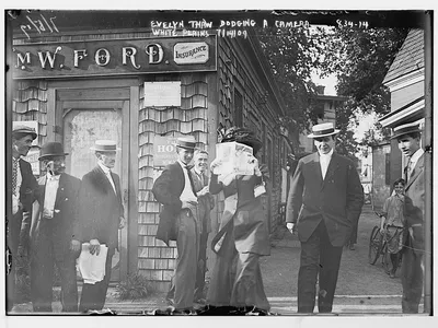 A woman named Evelyn Thaw dodges a camera, 1909